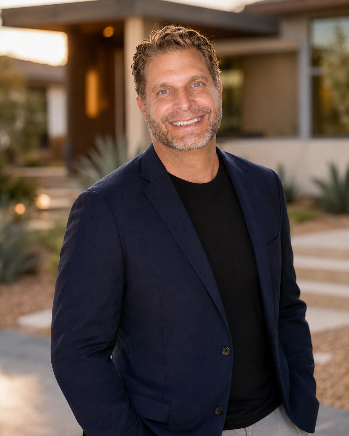 Jonathan, the advisor behind At Home AZ, smiling in front of a modern Arizona home
